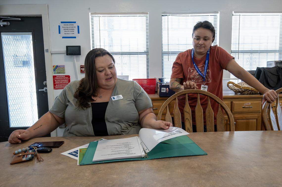 Cara Ramsey, director of programs and services, and Anali Otazo, program manager, look over the meal prep planner at Teresa's Place on Thursday, Sept. 11, 2025, in Kansas City. The shelter, formerly known as Pride Haven, recently underwent renovations and rebranding.