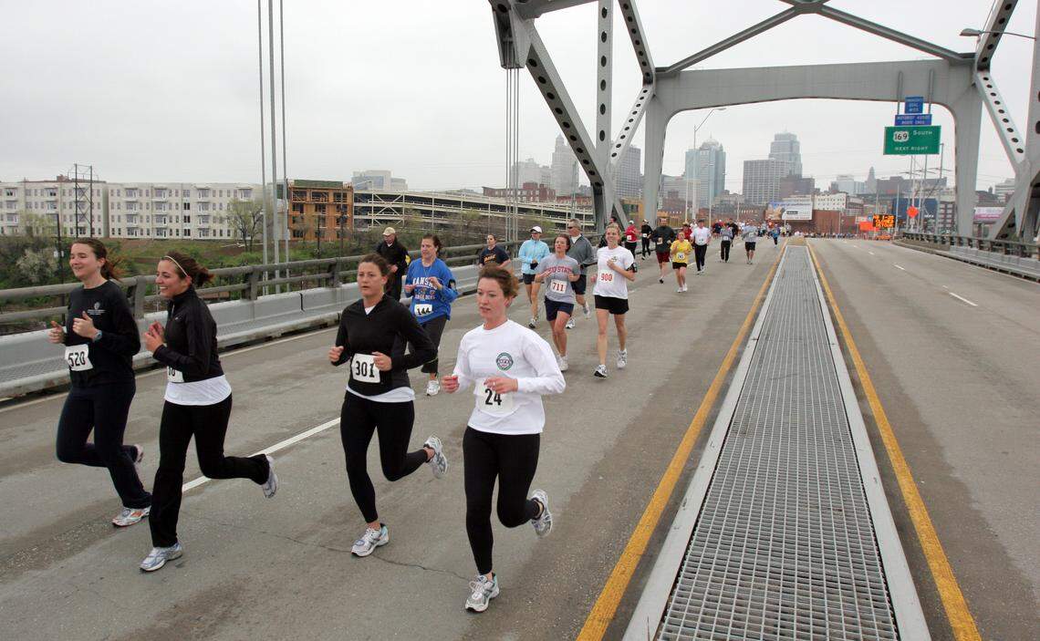 Runners cross the Buck O’Neil Bridge on their way to the Charles B. Wheeler Downtown Airport during an annual run in 2009.