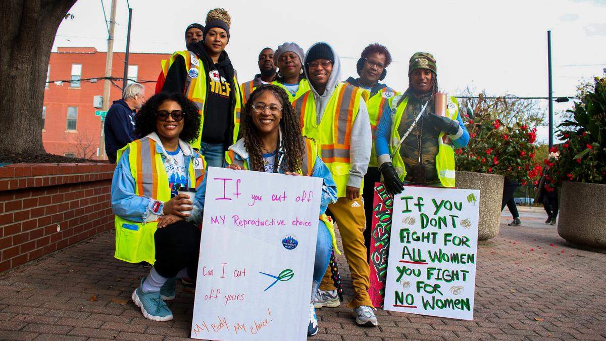 Natisha Johnson, 45, poses with a group of people in the United Auto Workers Local 249 union before a march in Kansas City on Nov. 2, 2024 advocating for reproductive rights in Missouri.