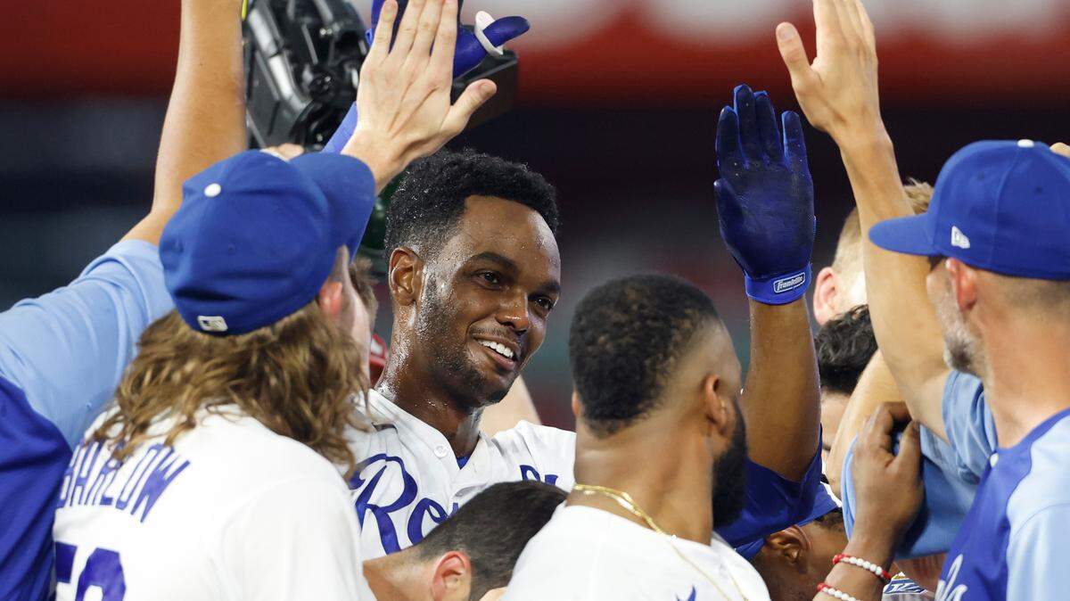 Kansas City Royals’ Michael A. Taylor, second from left, celebrates with teammates after driving in the game-winning run in the 10th inning of a baseball game against the Chicago White Sox at Kauffman Stadium in Kansas City, Mo., Wednesday, July 28, 2021. (AP Photo/Colin E. Braley)