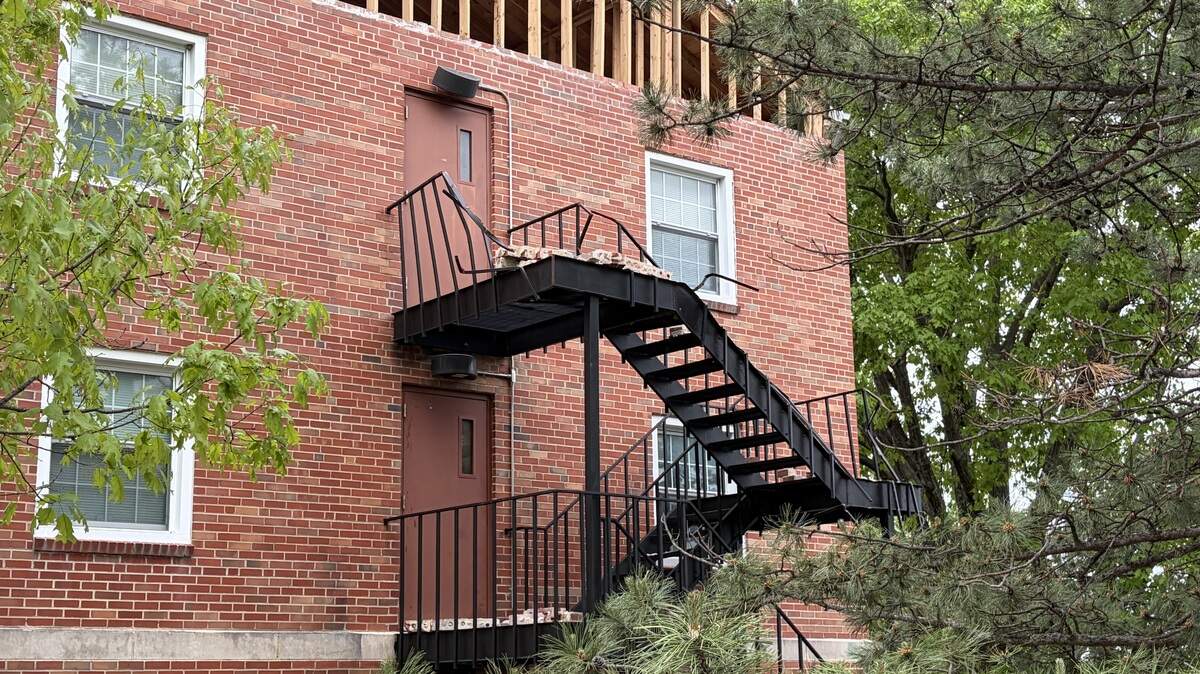 An entire section of bricks beneath the gable roof on the south side of Stephenson Scholarship Hall was dislodged in a storm early Monday morning, damaging the railing on a fire escape and rendering it inaccessible.