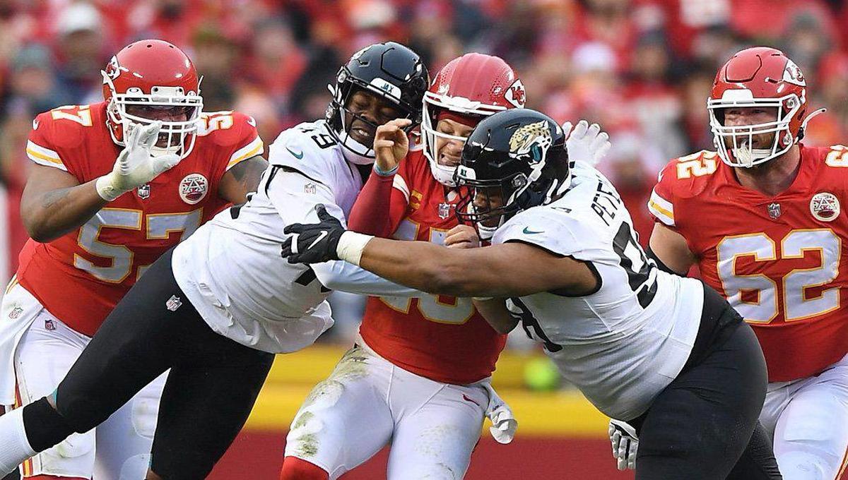 Kansas City Chiefs quarterback Patrick Mahomes is crushed by Jacksonville Jaguars defensive end Arden Key (49) and defensive tackle Corey Peters (98) in the first half during the Divisional Round game Saturday, Jan. 21, 2023 at GEHA Field at Arrowhead Stadium. Mahomes was injured on the play and came up limping.