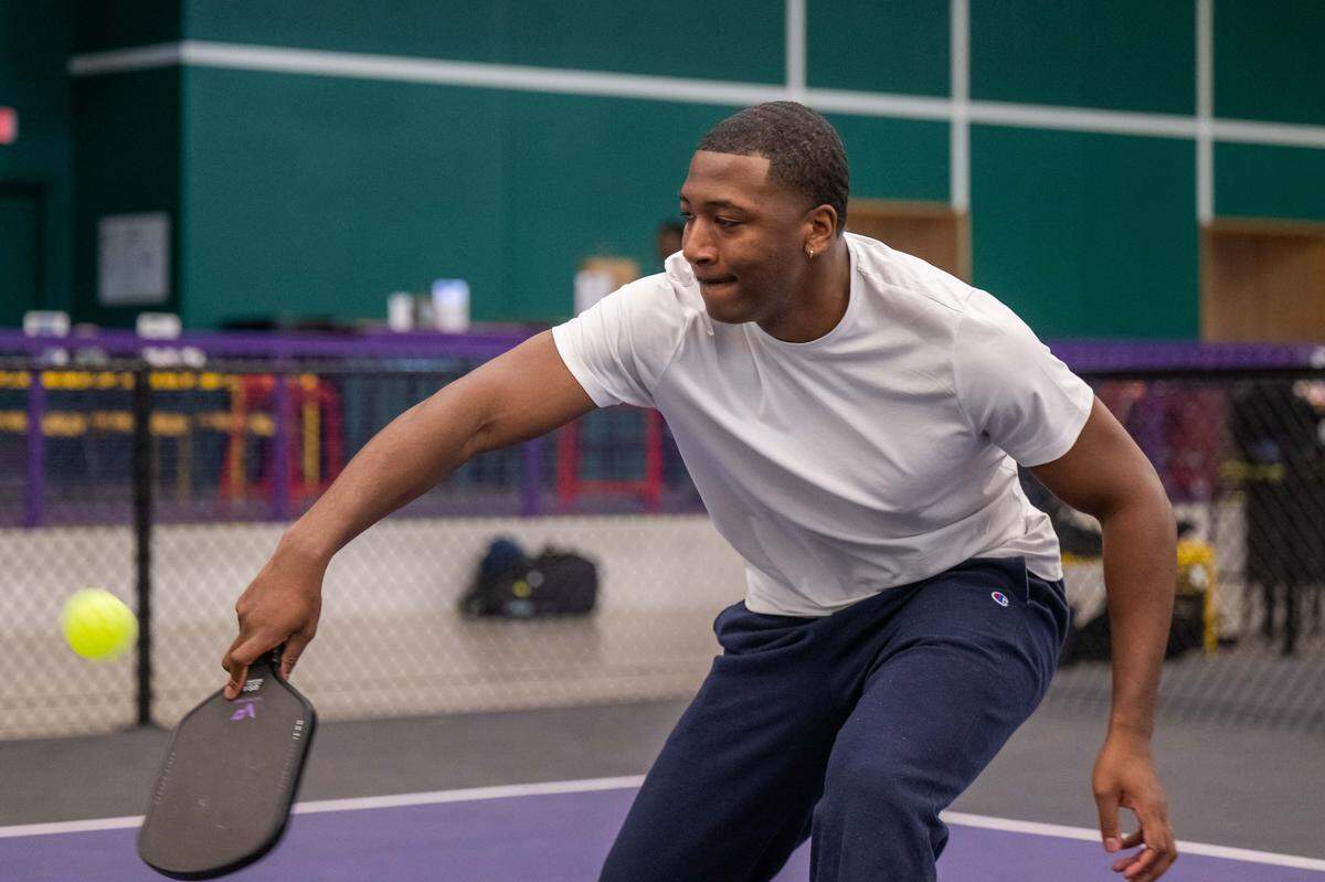 Brandan Jackson, founder of the Black Pickleball Club, returns a volley during a match at SW19 at the Stadium, on Sunday, Feb. 22, in Kansas City. Jackson created the club to find other Black people that enjoyed the game and to make the community feel welcoming and accessible.