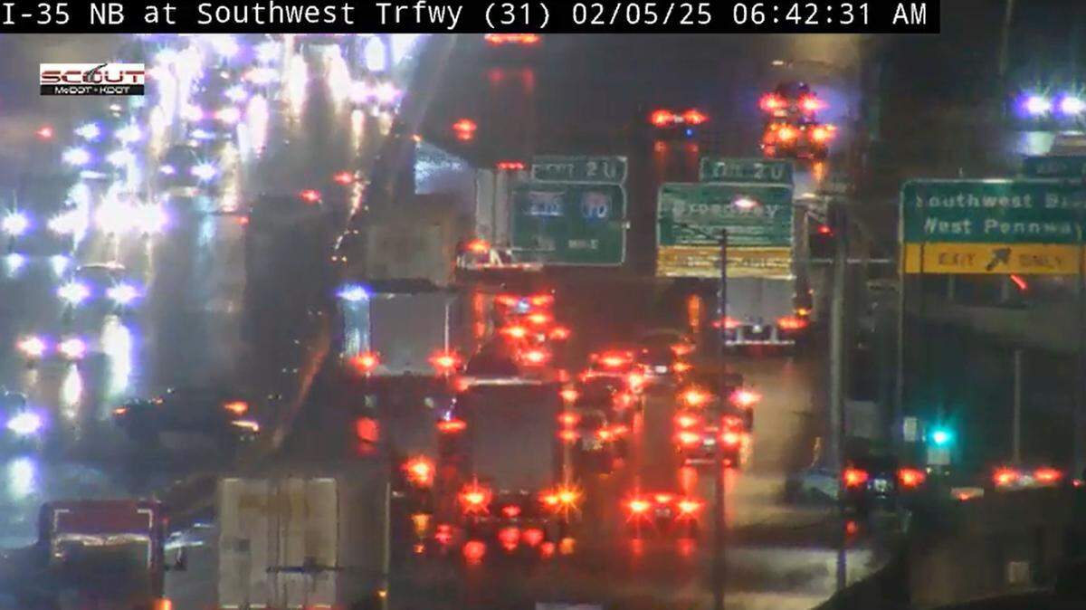 Traffic along northbound Interstate 35 on the west side of Kansas City downtown was at a standstill early morning after freezing drizzle coated the metro highways and roads with a thin layer of ice. Traffic cameras showed cars facing the wrong direction after they spun out. Drivers are urged to delay, if not cancel, their travel plans.