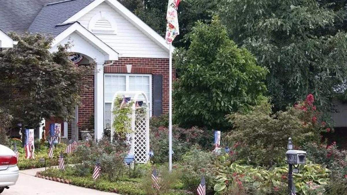 Janice and Carl Duffner's yard in St. Peters, Mo., is planted with flowers because she is allergic to grass.