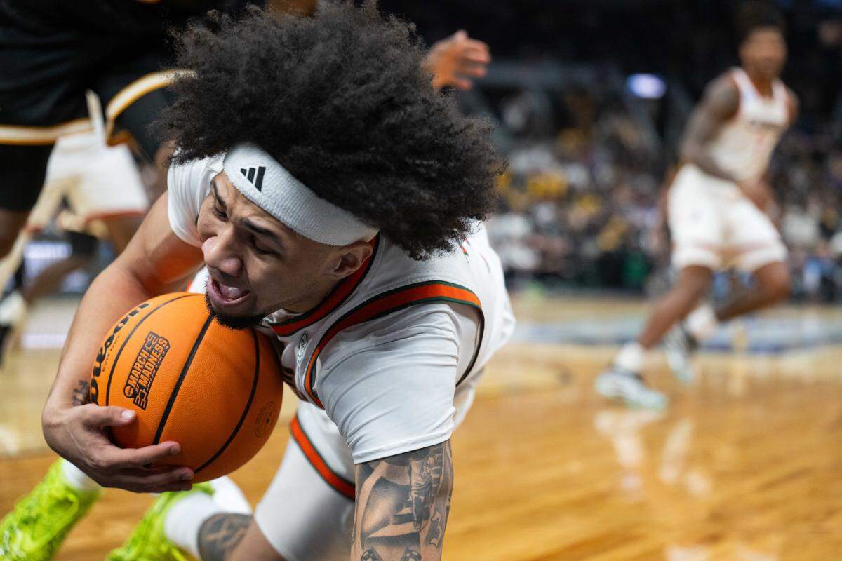 Miami Hurricanes guard Tre Donaldson (3) dives for a loose ball in the second half of the first-round NCAA Tournament matchup at Enterprise Center in St. Louis on Friday, March 20, 2026.