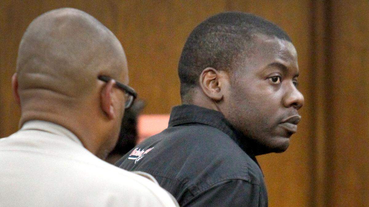 Marcus Benson (right) was taken to jail after his probation was revoked on Thursday, Oct. 10, 2013, in Jackson County Circuit Court in Downtown Kansas City.