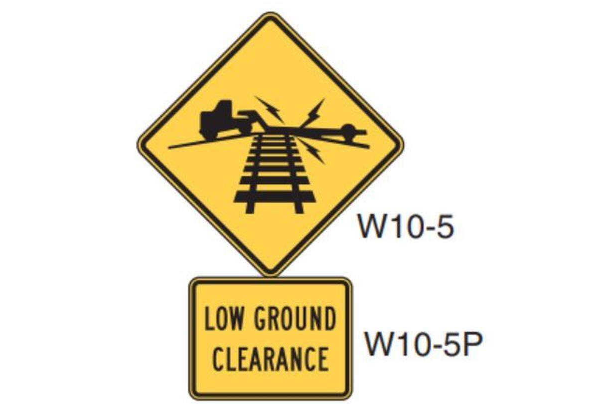 A black and yellow sign depicting a vehicle stuck on a railroad crossing is a required warning for motorists about low ground clearance.&nbsp;A Federal Railroad Administration report did not note the absence of the sign at the Porche Prairie crossing. 