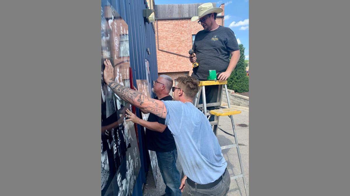 Dave Eames, Colin Aubuchon and Ben Wine of Fossil Forge Design installed the We Are Lee’s Summit public art at the Downtown Lee’s Summit Main Street office.
