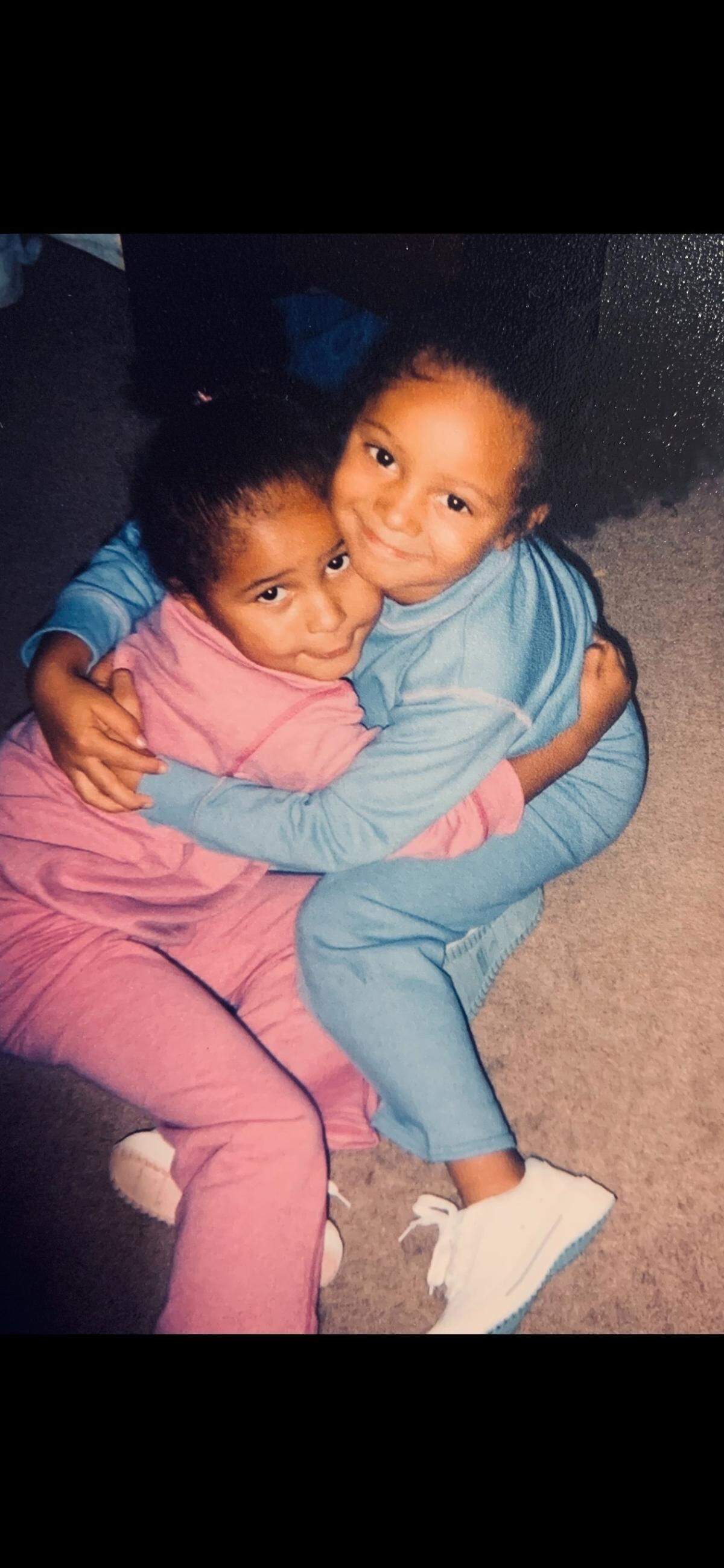 Shayla (left) and Sydnee (right) Curts hug each other in a photo. Their mother would always dress them like twins, Sydnee said.