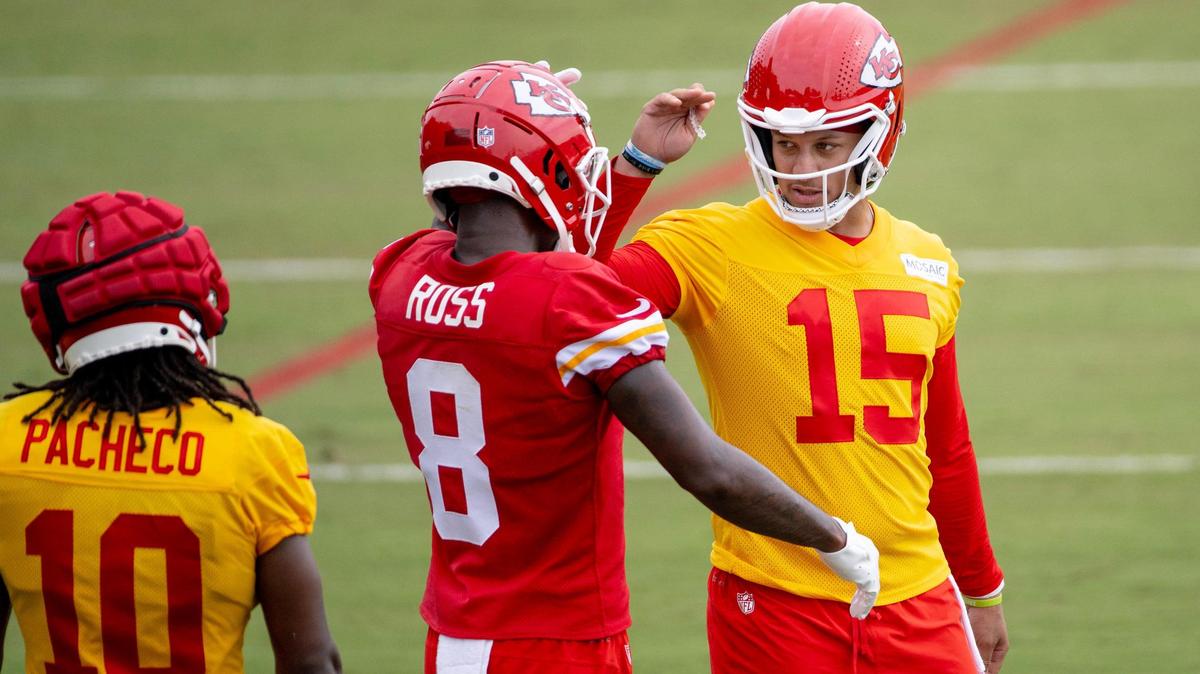 Kansas City Chiefs quarterback Patrick Mahomes (15) reaches out to pat wide receiver Justyn Ross (8) on the helmet during a Chiefs training camp practice on Tuesday, July 25, 2023, in St. Joseph.