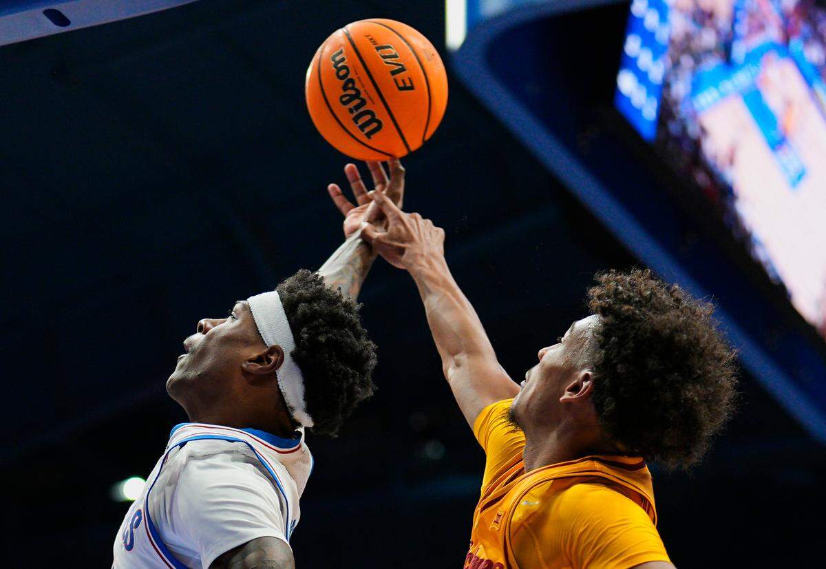 Kansas Jayhawks guard AJ Storr, left, puts up a shots as Iowa State Cyclones guard Curtis Jones defends during a college basketball game at Allen Fieldhouse in Lawrence, Kansas, on Monday, Feb. 3, 2025.