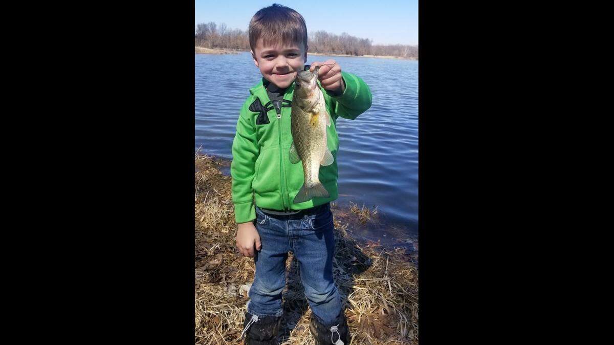 Five-year-old Sawyer Rushton, accompanied by his dad, Jeremy, was among the happy anglers at James A. Reed recently when the lakes finally thawed out. He proudly hoisted a bass he caught on his favorite rattle trap lure.