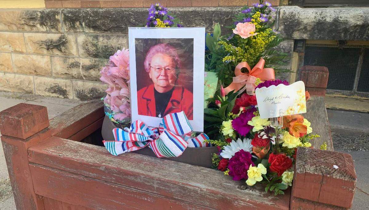People left flowers outside the Marion County Record office in remembrance of co-owner Joan Meyer.