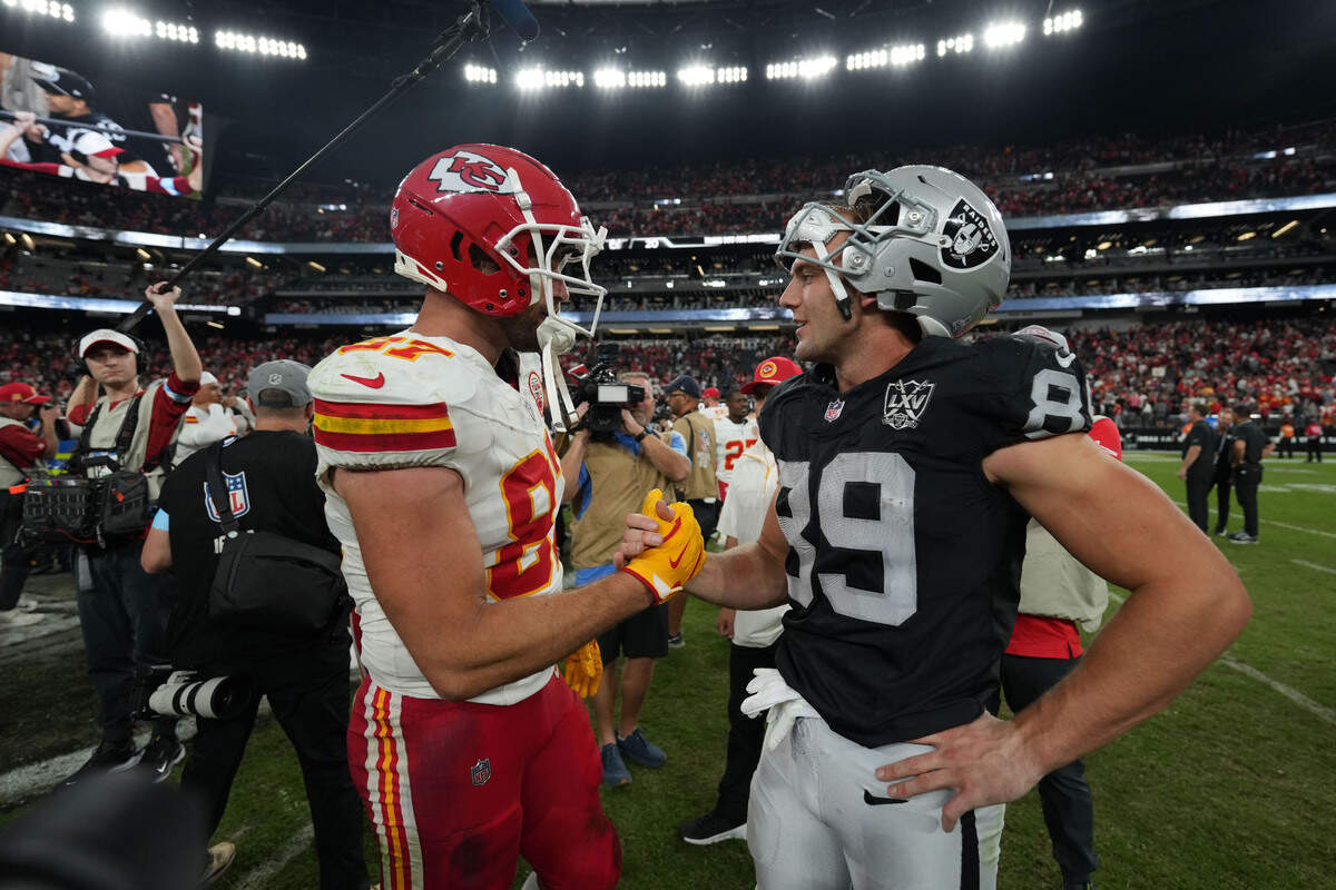 Kansas City Chiefs tight end Travis Kelce (87) and Las Vegas Raiders tight end Brock Bowers (89) interact after the game at Allegiant Stadium.
