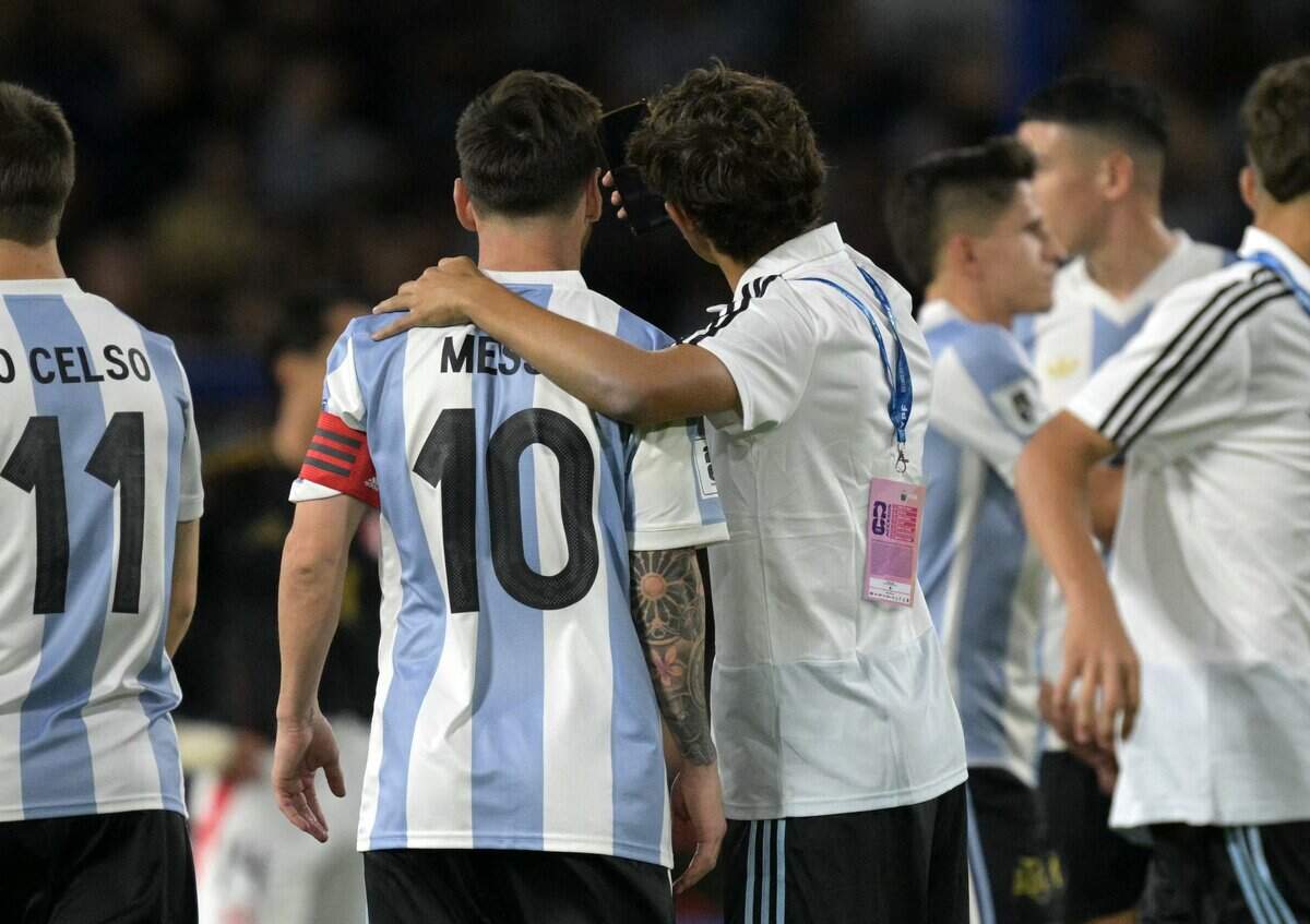 Argentina's forward Lionel Messi, No. 10, poses for a selfie with a ball boy at the end of the 2026 FIFA World Cup South American qualifiers football match between Argentina and Peru at the La Bombonera stadium in Buenos Aires on November 19, 2024.