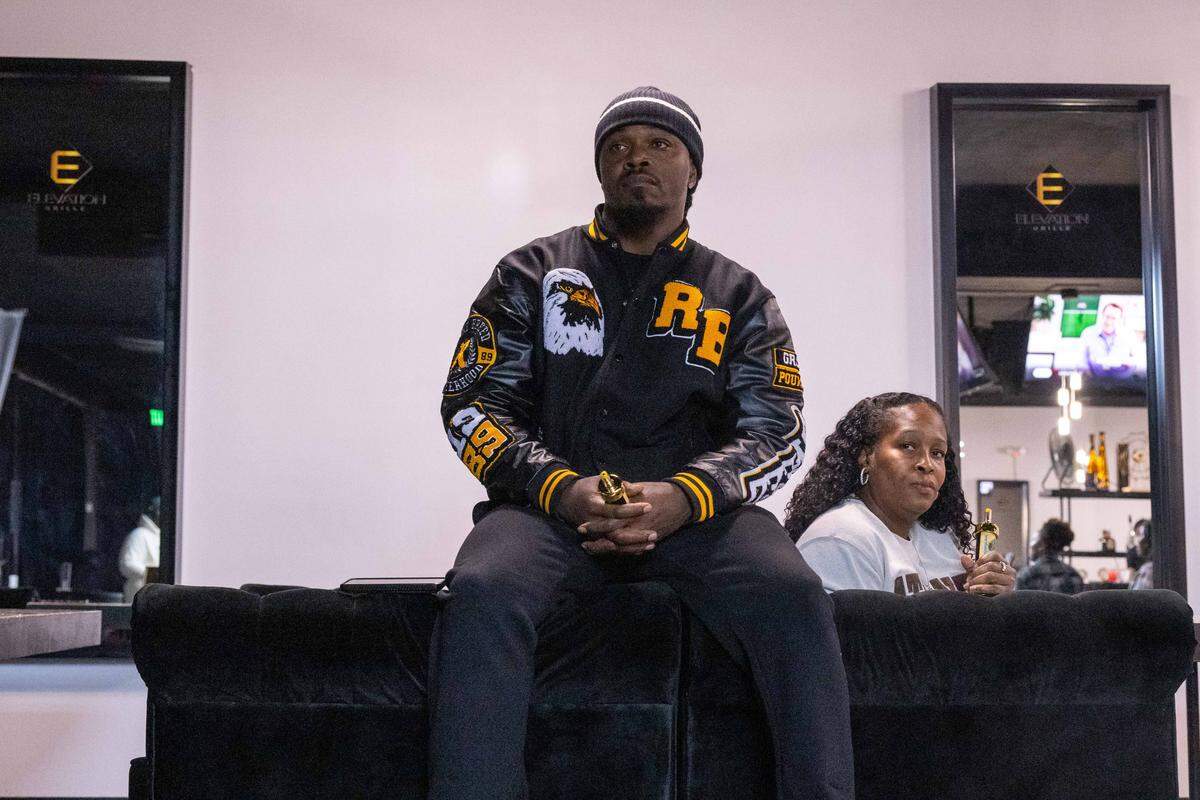 Former Chiefs player Alfonso Hodge watches performers during Soul Sessions, Kansas City's longest running open mic night. The event recently moved from Juke House on 18th and Vine Street to his bar and grill, Elevation Grille, in Raytown.