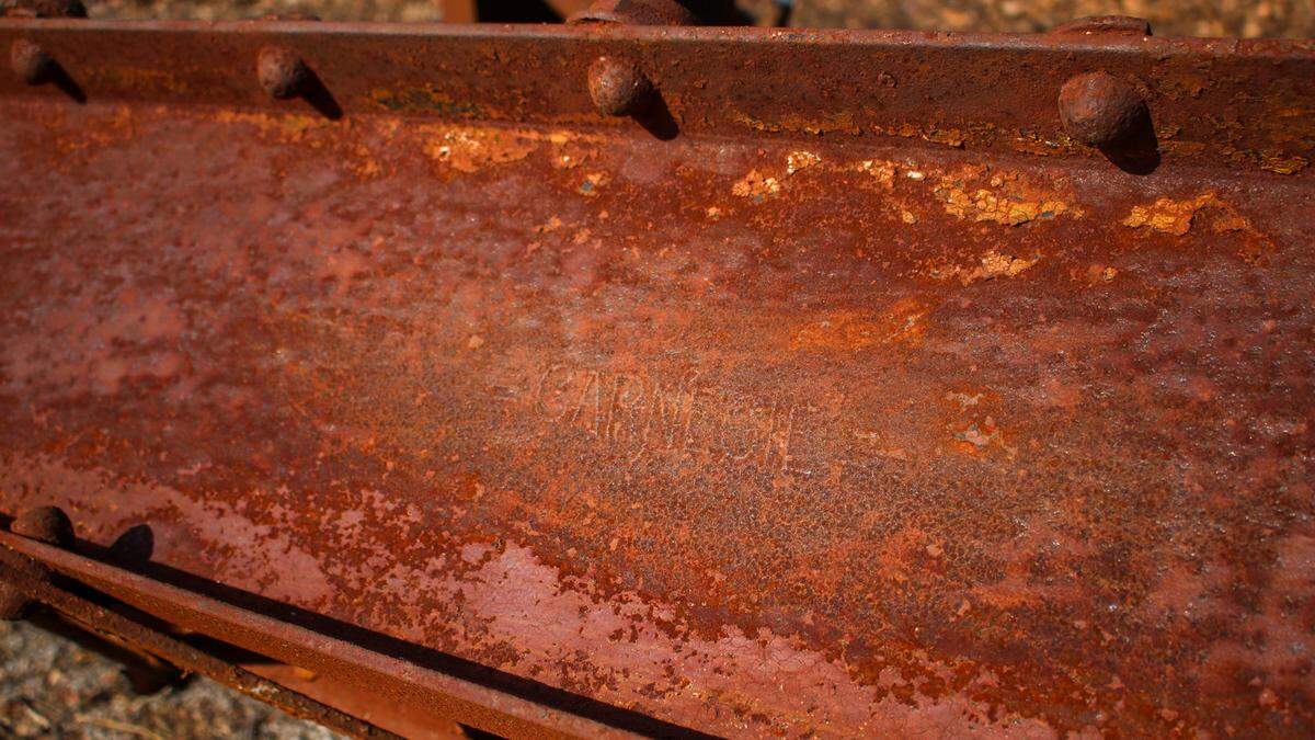 A rusty metal beam bearing the name “Carnegie” is seen in the rubble of a demolished water tower at South Osage Street and West Pacific Avenue in Independence.