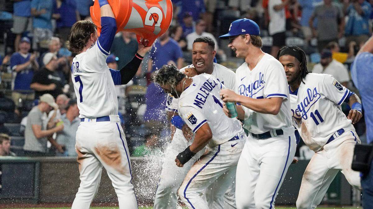 Royals right fielder MJ Melendez (No. 1) gets doused by shortstop Bobby Witt Jr. and mobbed by other teammates after scoring the game-winning run against the New York Mets on a 10th-inning balk Tuesday night at Kauffman Stadium.