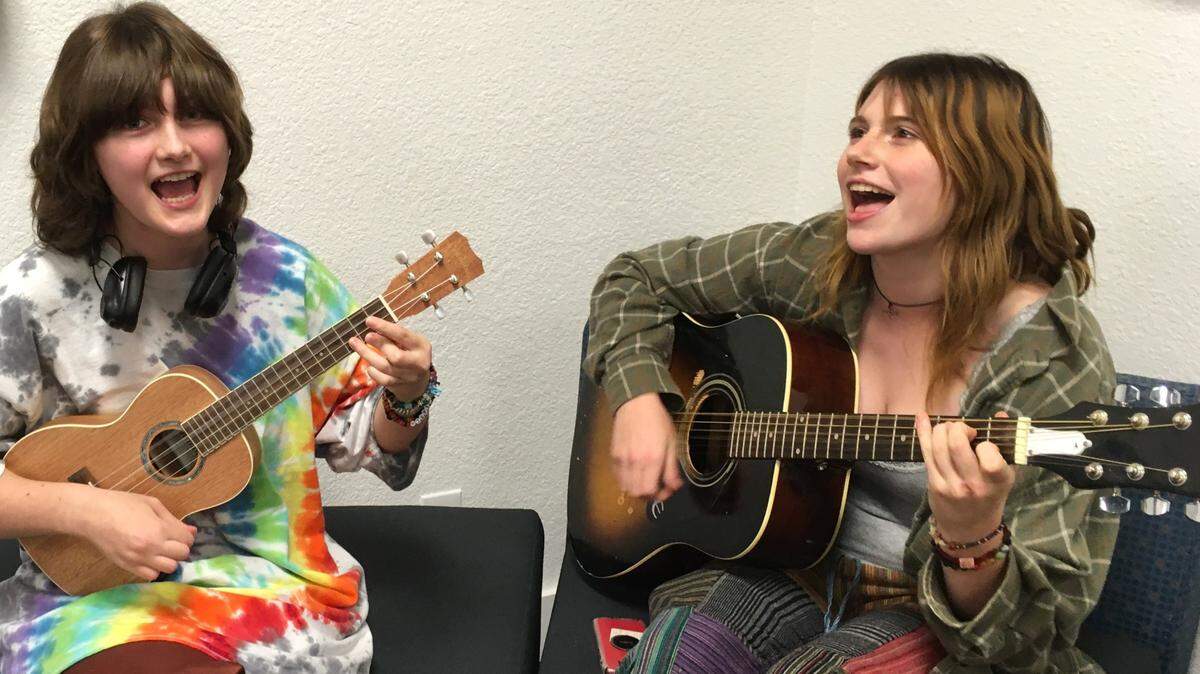 Sophomores Alastor Reynolds from Sumner Academy of Arts and Science and Clementine Gogol from Shawnee Mission East High School practice their instruments in the music room of Tyler’s House in Mission.