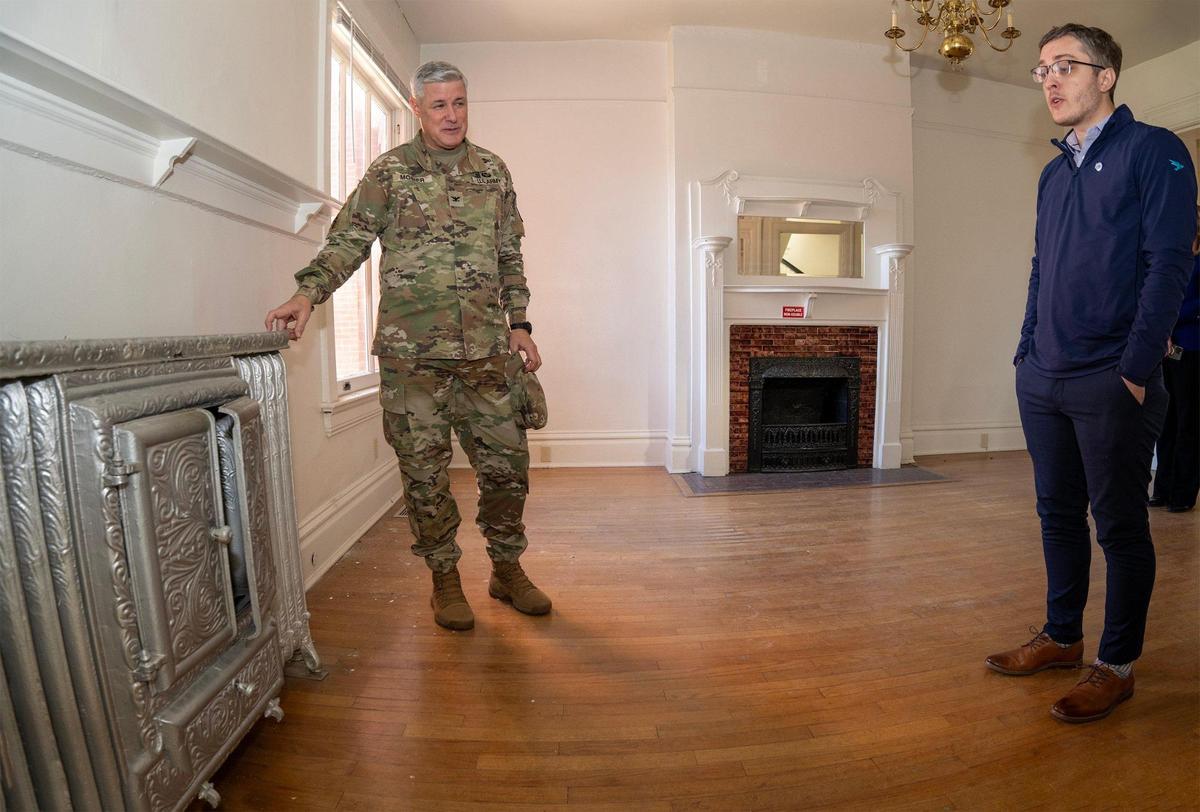 Col. Duane Mosier, Fort Leavenworth’s garrison commander, and Chase Cornett, who manages the Michaels Organization’s housing at the post, toured a 1901 historic home.
