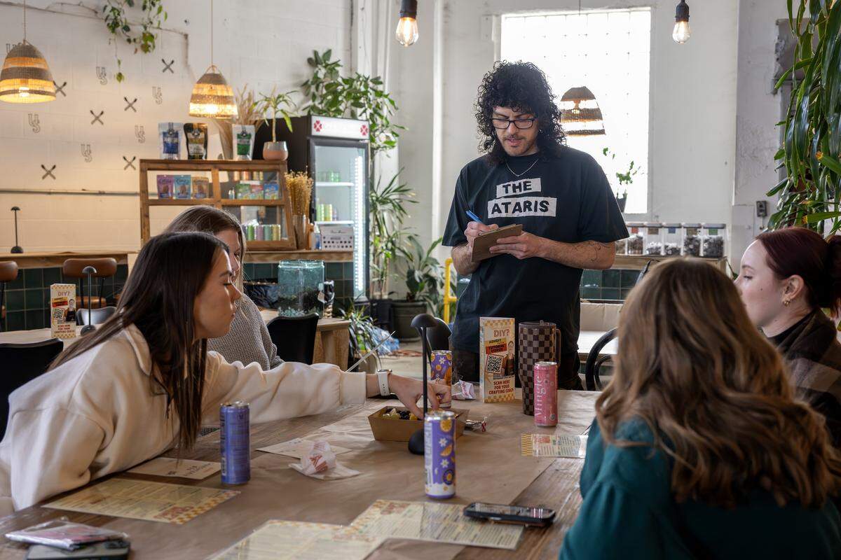 Hamza Coustantine takes customer orders at ADHDIY Craft Cafe on Saturday, Feb. 7, 2026, in Kansas City,