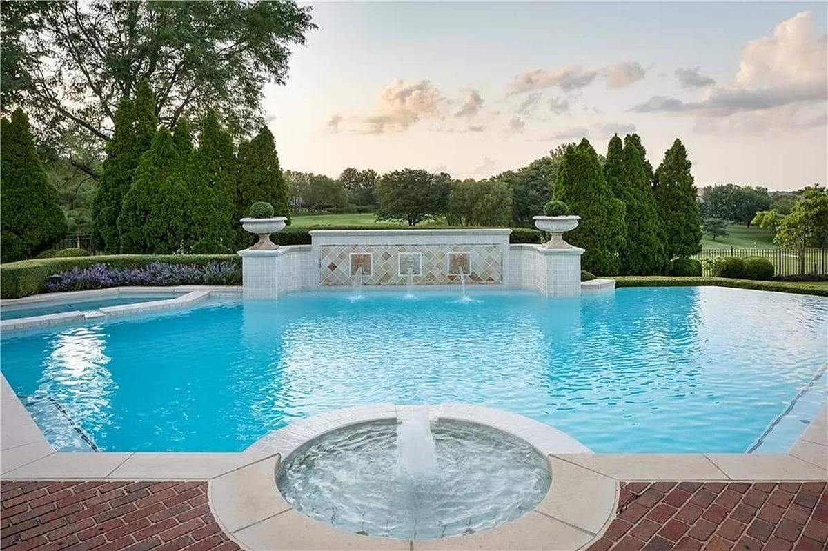 The backyard pool of the Leawood home overlooks the Hallbrook golf course.