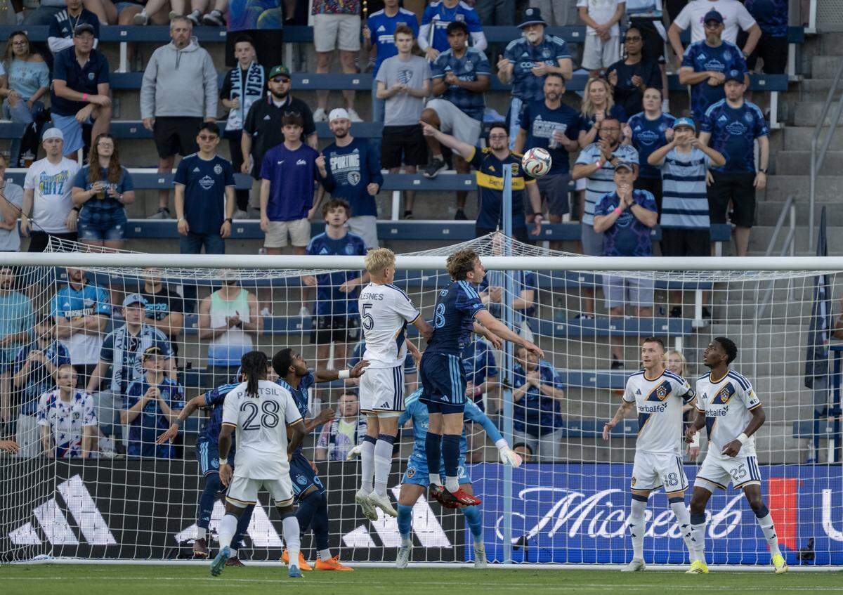 Sporting Kansas City defender Wyatt Meyer (28) and LA Galaxy defender Jakob Glesnes (5) deflect the ball over the goal during the first half at Sporting Park on Wednesday, May 13, 2026, 2026, in Kansas City, Kansas,