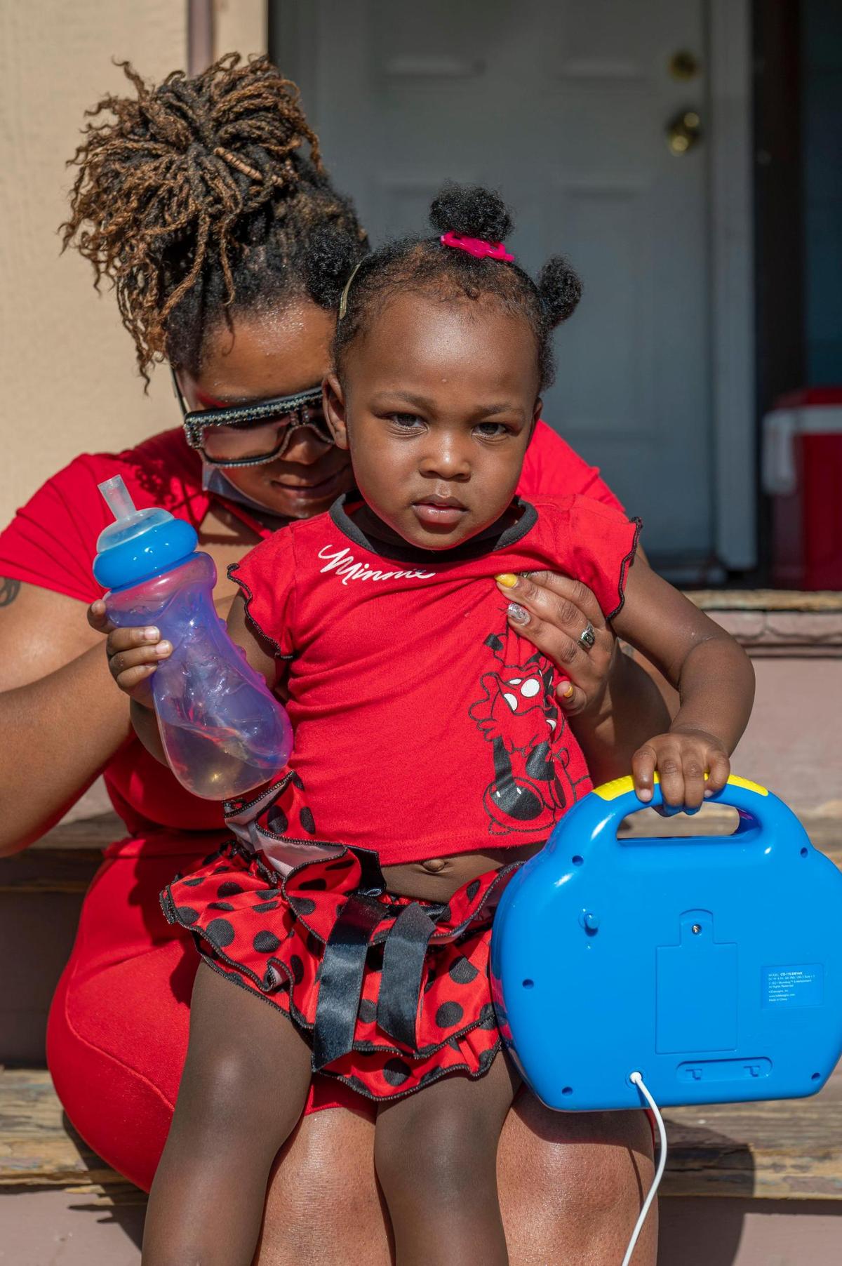 Kristal Findley holds her daughter Laina at a family gathering in Oak Park. Laina’s father, Derrick Davis, was killed just hours before she was born.