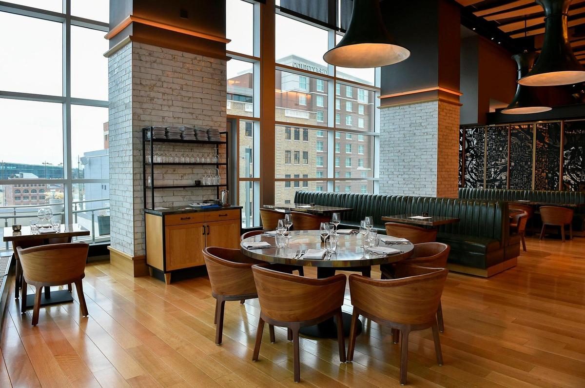 The dining room features floor-to-ceiling windows.
