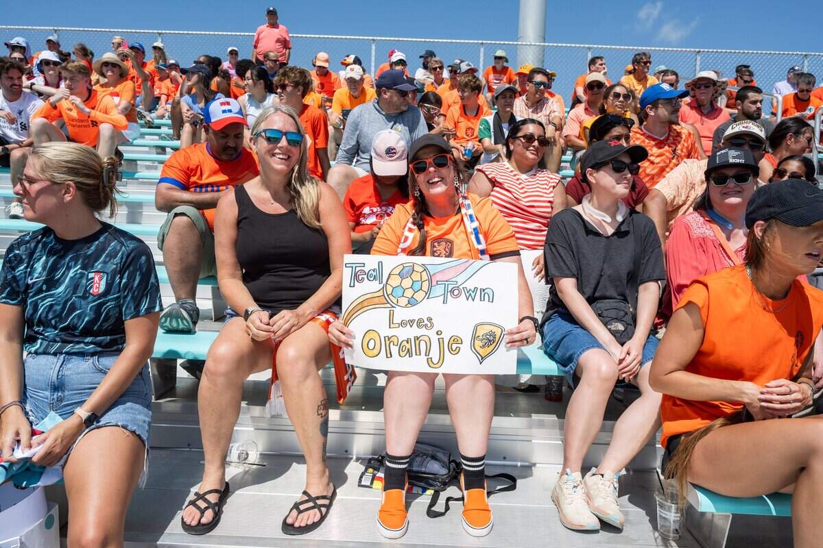 Danica McCallister holds a sign in support of the “Oranj” during the Netherlands soccer team open practice on Wednesday, June 10, 2026, in Riverside. The Dutch national team will train between matches at the Kansas City Current training facility.