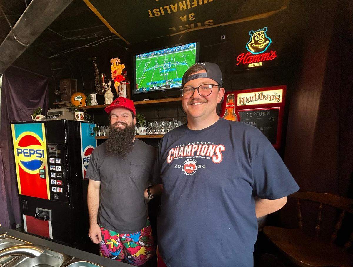 Gnarly Hussle owners Alex Quinn (left) and Pat Clifton behind the new bar they’ve opened inside their Raytown vintage shop.