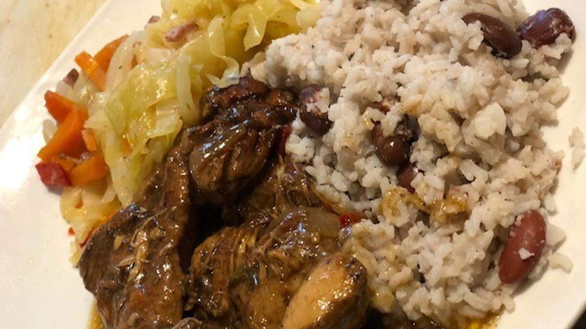 Taste’s brown stewed chicken with rice, peas and cabbage .