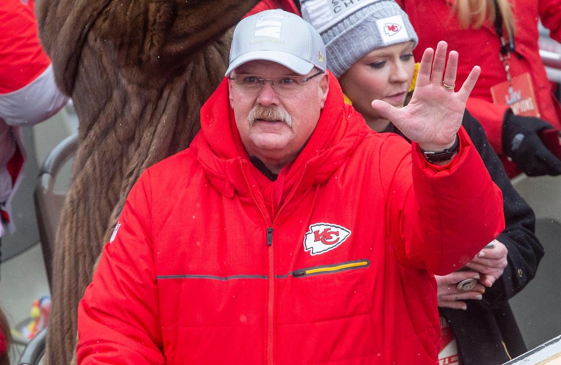 Kansas City Chiefs coach Andy Reid waves to his admirers while riding down Grand Boulevard in the Super Bowl victory parade Wednesday.