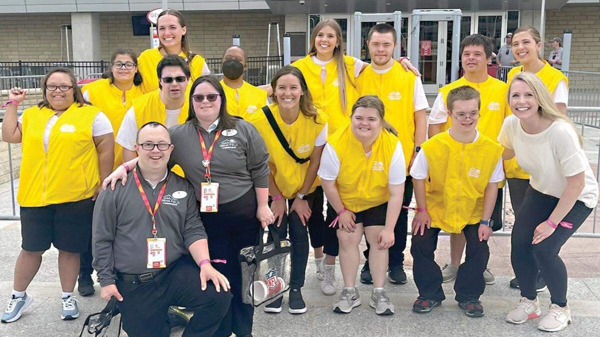 Madison Millentree (back left) is one of 18 individuals with Down syndrome employed by the Chiefs through a partnership with Down Syndrome Innovations.