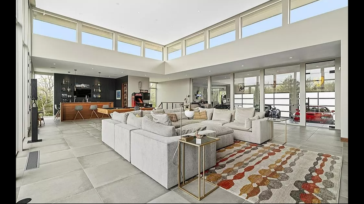 A peek inside one of the living rooms at 7295 W. 183rd St. in Stilwell. Cars inside the garage are on full display and can be seen through the glass.
