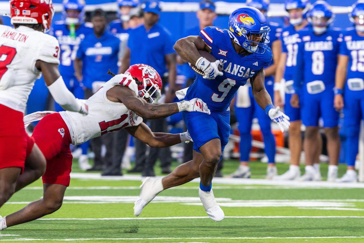 Kansas Jayhawks running back Daniel Hishaw Jr. (9) runs the ball for a short gain in the second half of the Jayhawks game vs. the Fresno State Bulldogs on Saturday, Aug. 23, 2025, at David Booth Kansas Memorial Stadium, in Lawrence.