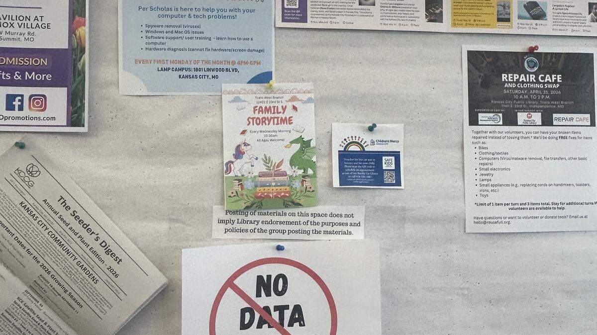 Messaging in opposition to a proposed $150 billion Nebius AI data center appears on a community bulletin board at the Trails West Branch of the Kansas City Public Library. The library was one of several stops on a resident-led petition drive, aiming to reverse tax breaks for the data center via referendum.