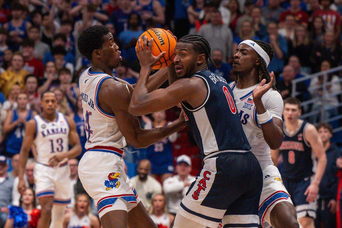 Kansas Jayhawks guard Melvin Council Jr. (14) and guard Jamari McDowell (11) double team Arizona Wildcats guard Jaden Bradley (0) in the second half on Monday, February 9, 2026, at Allen Fieldhouse.
