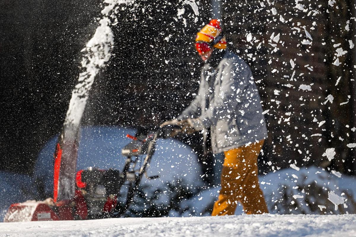 Nick Garcia seen behind flurries of flying snow, navigated a snow blower to clear his father-in-law, Paul Peterson’s, driveway near Loose Park in Kansas City on Friday, Jan. 10, 2025. The second wind of snow came days after a foot of snow fell on the metro. Peterson noted that with the accumulation and drifting, snow on his property measured up to 16 inches deep in some spots. 