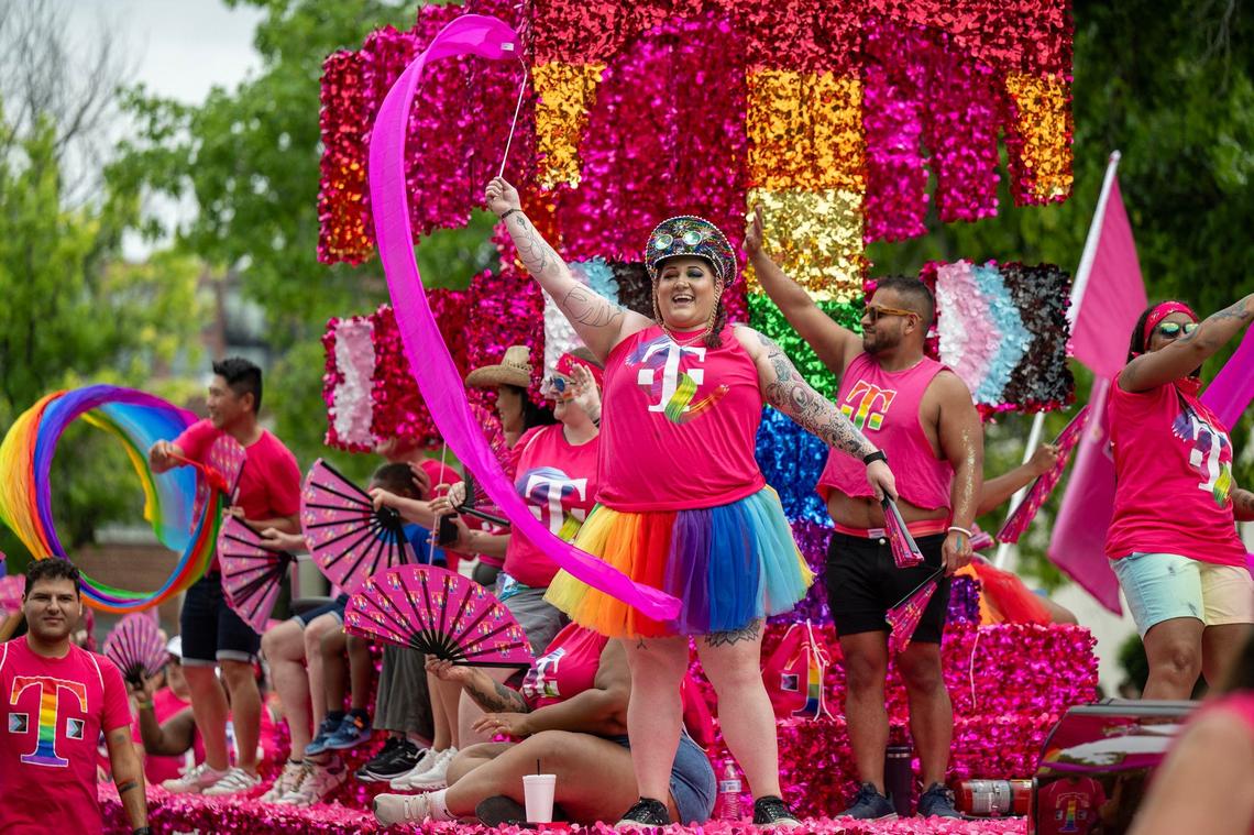 Participants waved banners as they rode on the T-Mobile float during the KC Pride Parade.
