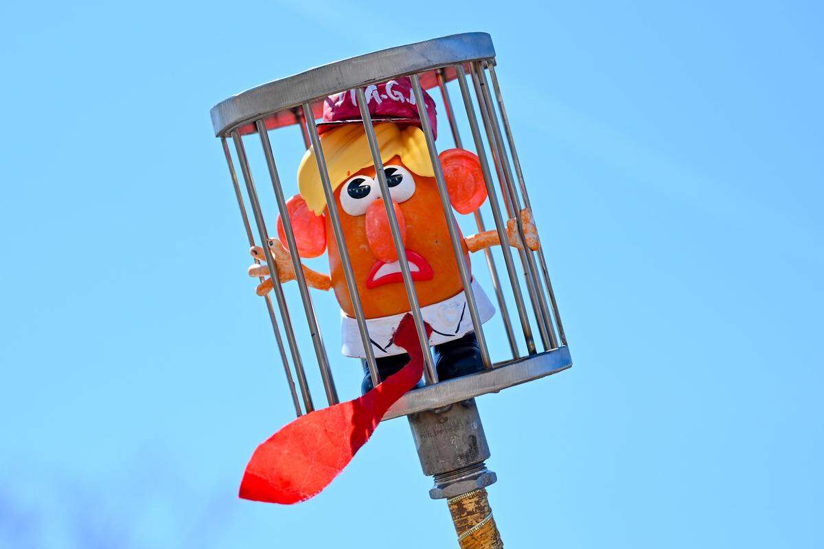 A protester holds up a figure depicting President Donald Trump during a No Kings rally against the Trump administration in Mill Creek Park near the Country Club Plaza on Saturday, March 28, 2026.