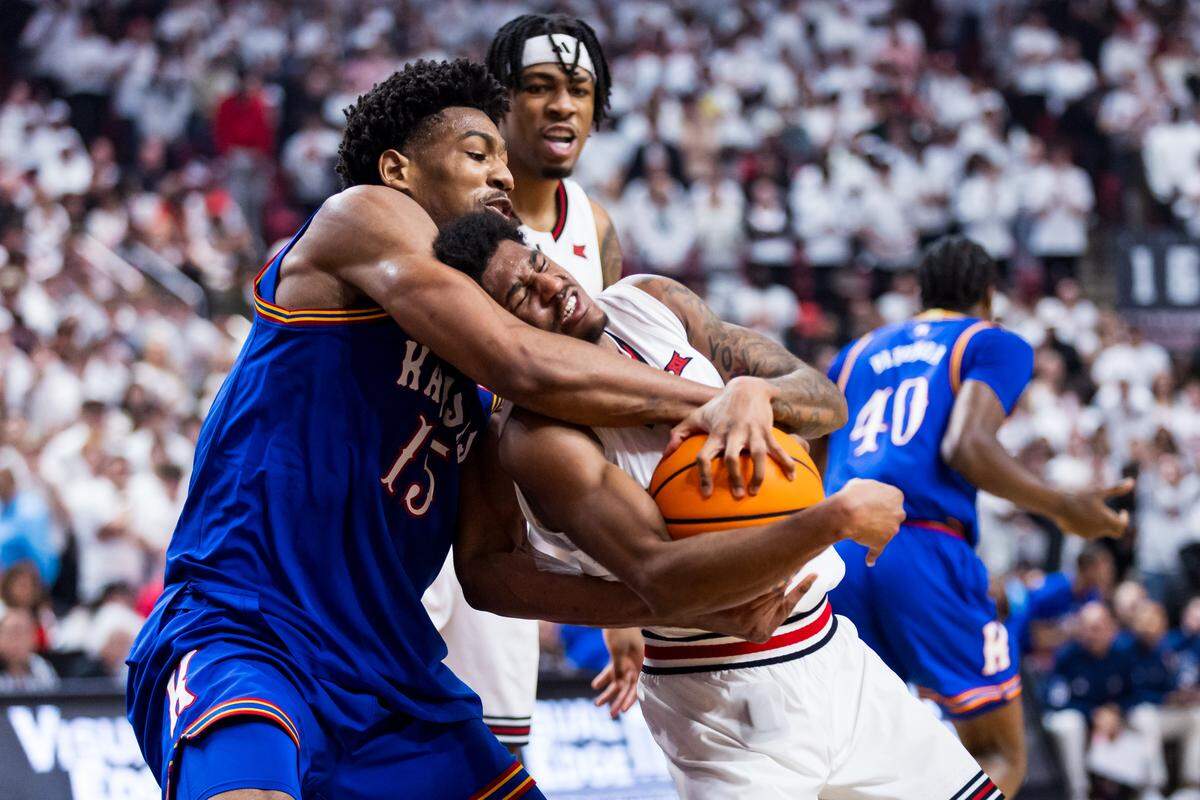 Bryson Tiller #15 of the Kansas Jayhawks and Jaylen Petty #11 of the Texas Tech Red Raiders battle for the ball during the first half of the game at United Supermarkets Arena on Feb. 2, 2026 in Lubbock, Texas.