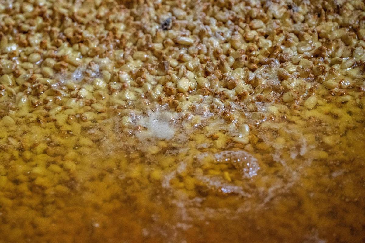 Corn cooks inside a large oven at Perez Food Products on Thursday. The process is largely automated, but a crew of about 10 keeps things running.
