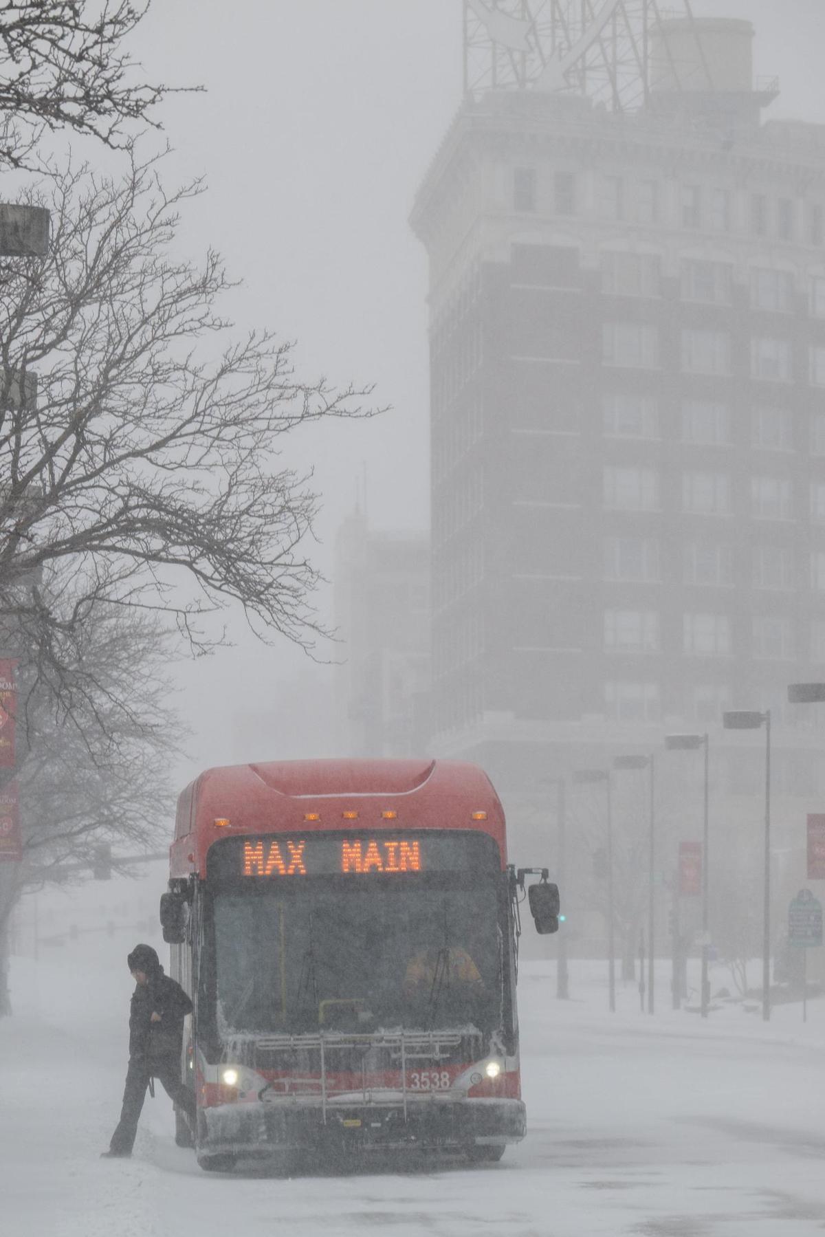 A pedestrian steps off a RideKC bus near Crown Center in Kansas City on Sunday, Jan. 5th, 2025.