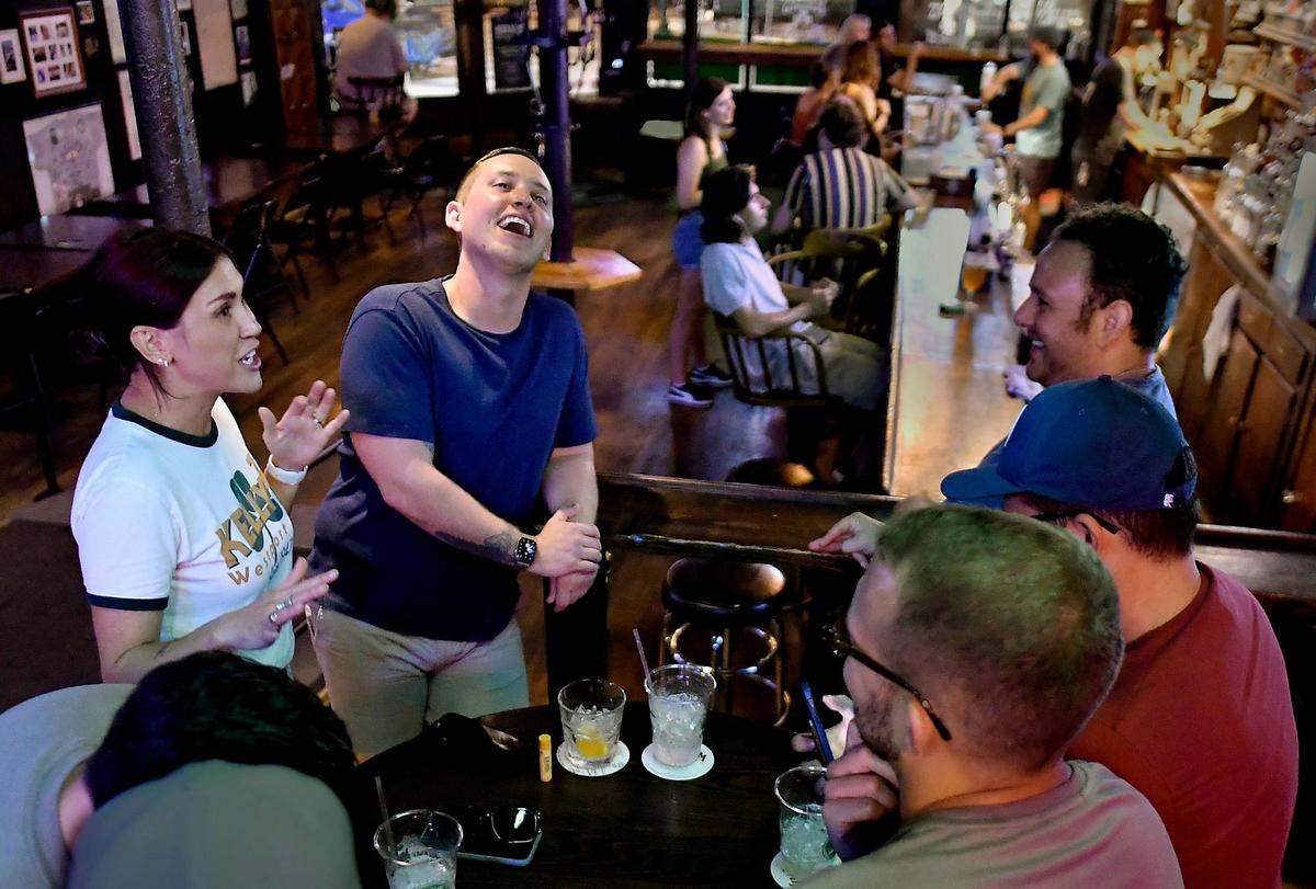 Colleen Kelly, left, chatting with customers on a recent weeknight. “I think most people leave their job feeling drained,” she said. “I leave feeling reenergized.”