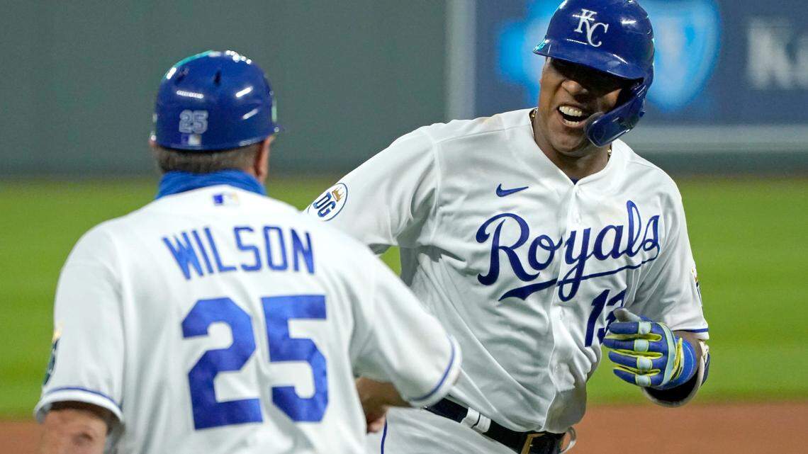 Kansas City Royals’ Salvador Perez celebrates with third base coach Vance Wilson after hitting a three-run home run during the first inning of the team’s baseball game against the Detroit Tigers on Thursday, Sept. 24, 2020, in Kansas City, Mo. (AP Photo/Charlie Riedel)