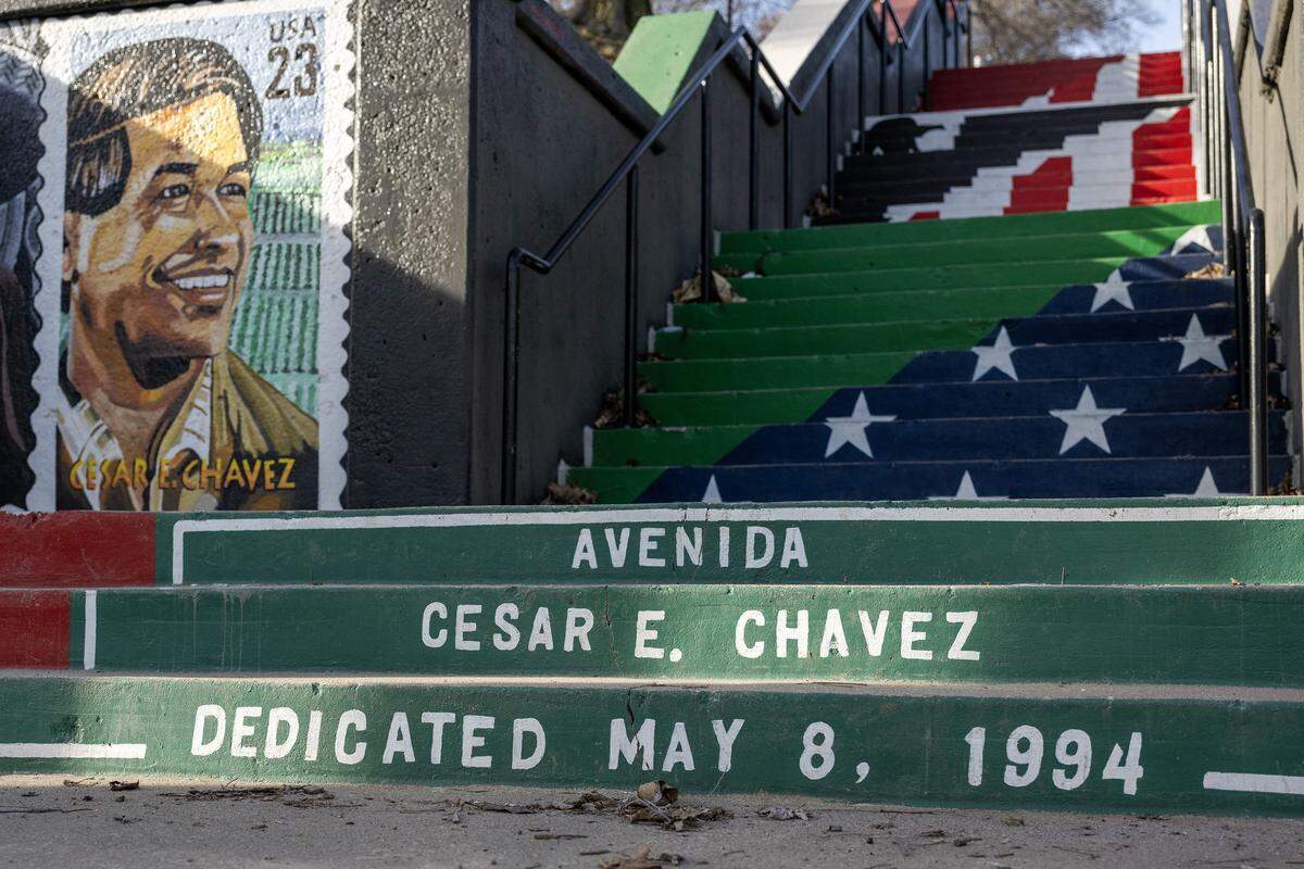 The words “Avenida Cesar E. Chavez” and “Dedicated May 8, 1994” are painted on the steps leading to Gage Park in Kansas City's West Side neighborhood on Thursday, March 19, 2026.