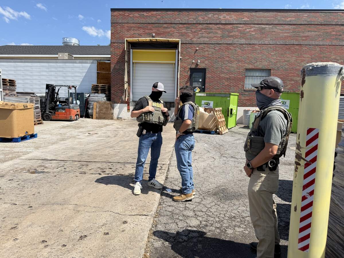 Law enforcement agents speak outside of La Fontanella Foods on Thursday, July 9, after several people appears to be arrested at the facility in Kansas City.