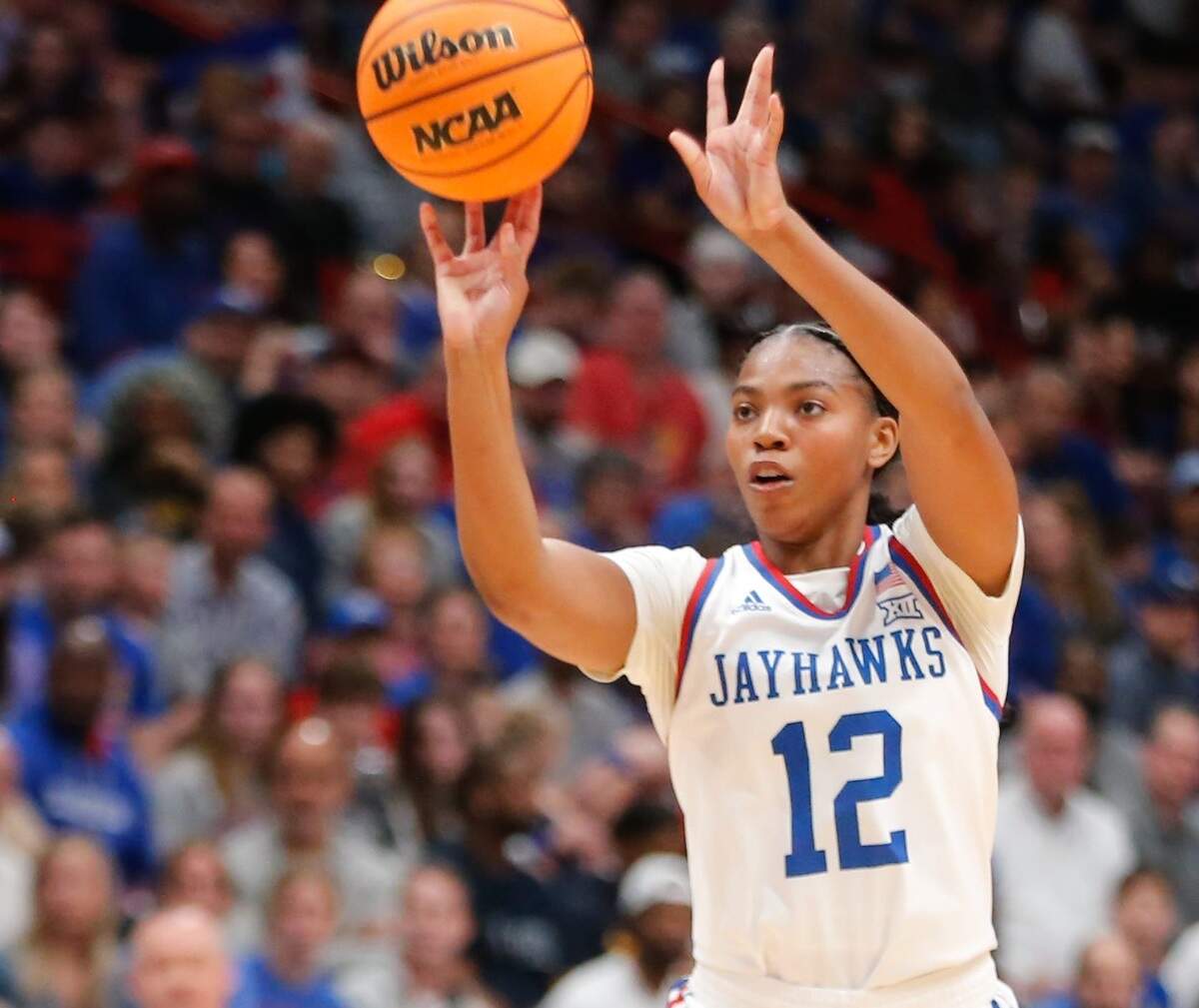 Kansas Jayhawks freshman guard S’Mya Nichols shoots a 3-pointer during a late-February game against rival K-State at Allen Fieldhouse.